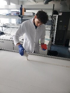 Man works on the coating of a surface